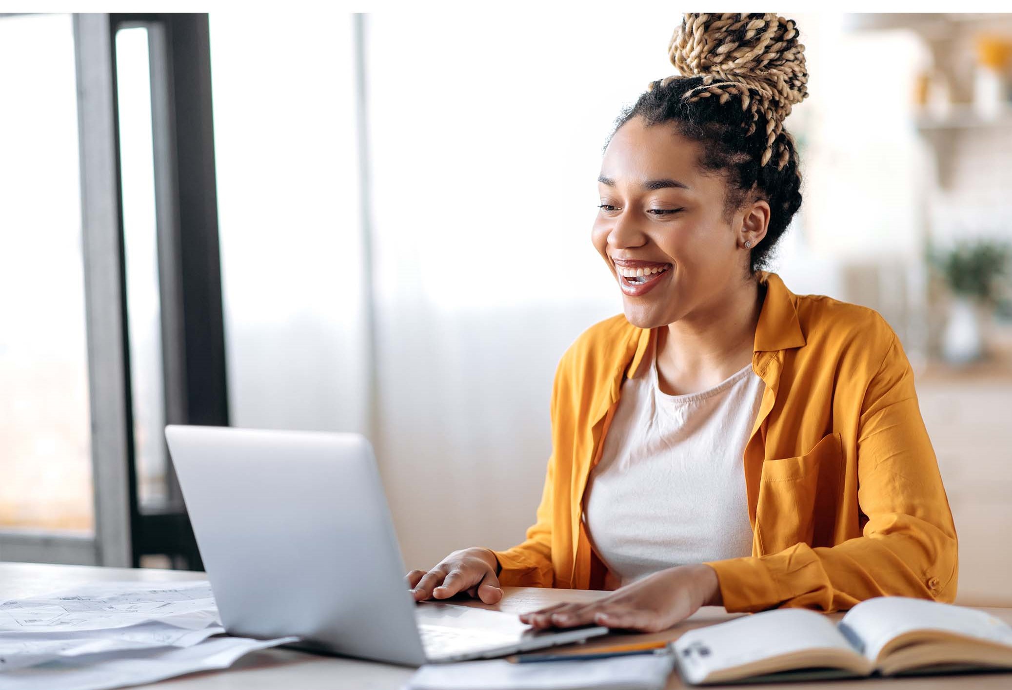 woman laughs at computer