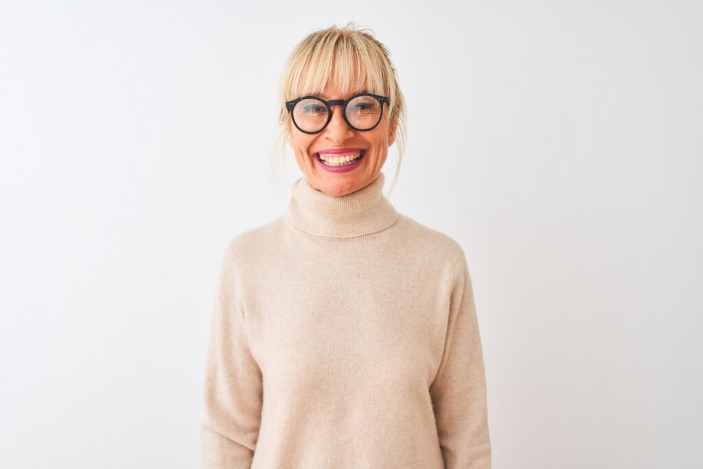 middle aged woman with glasses smiling