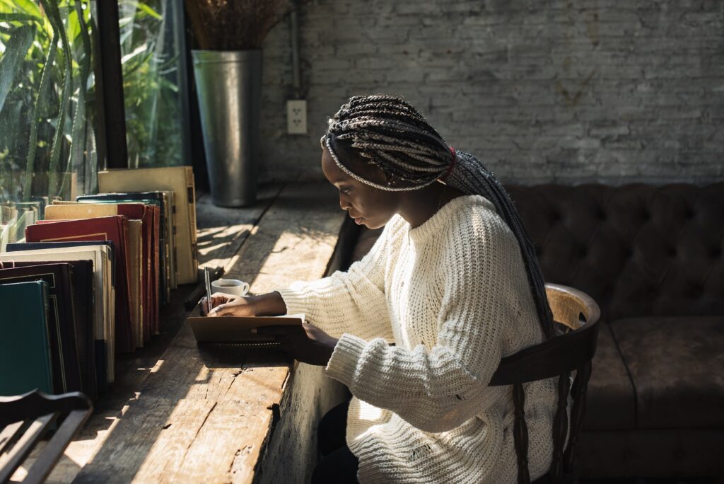 Portrait of a woman journaling at a coffeeshop